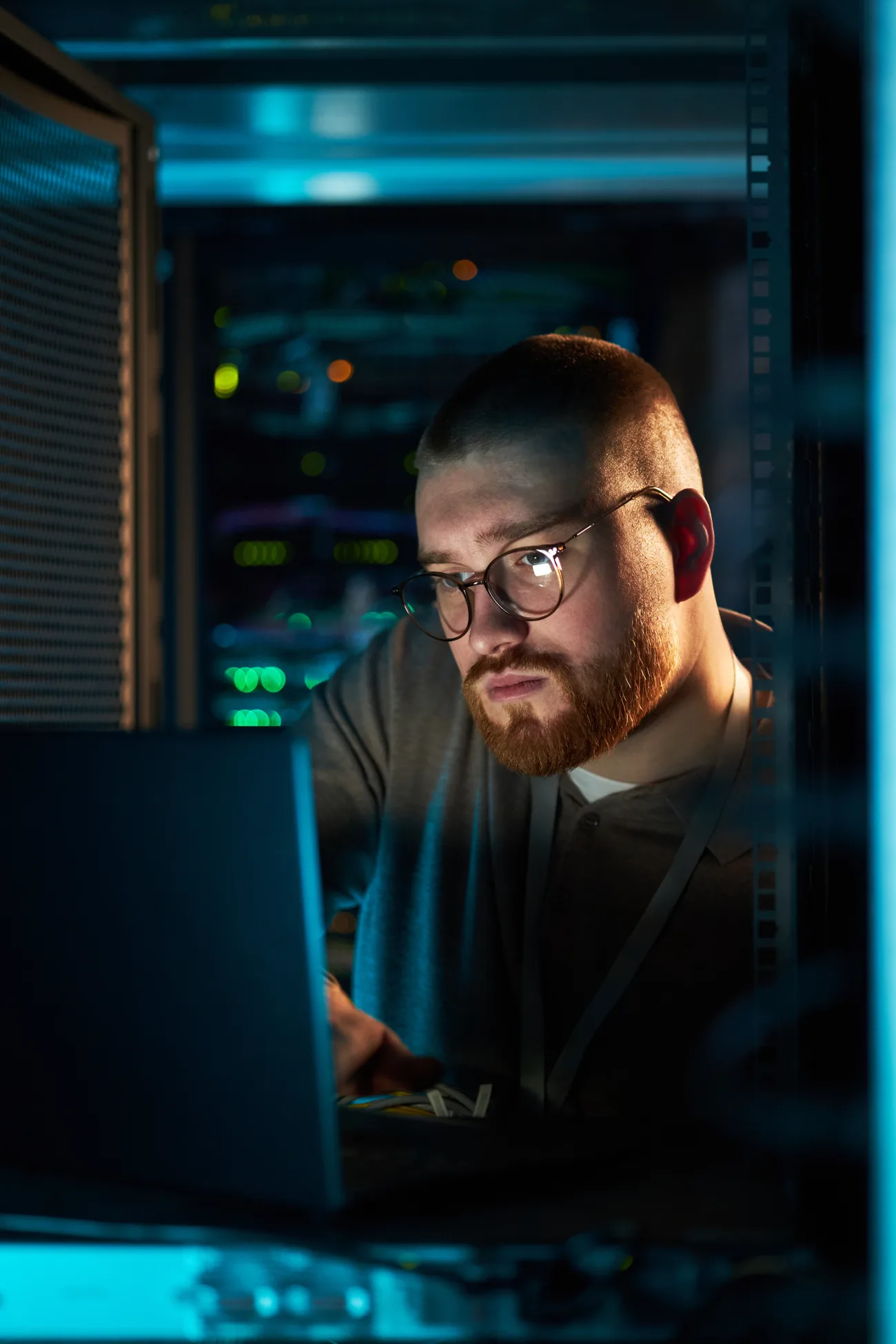 A technology professional working in a server room.