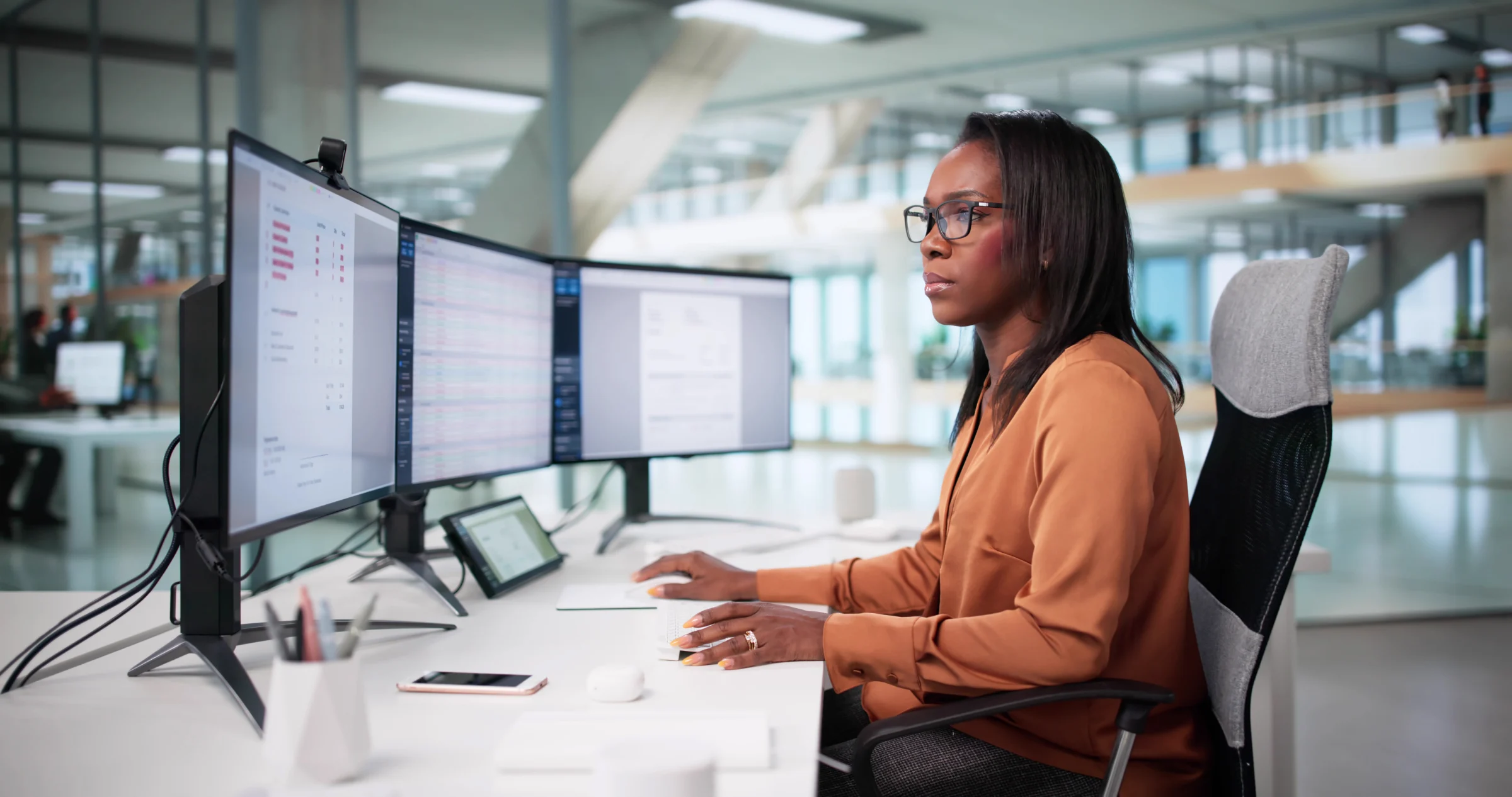 Professional monitoring several computer screens.