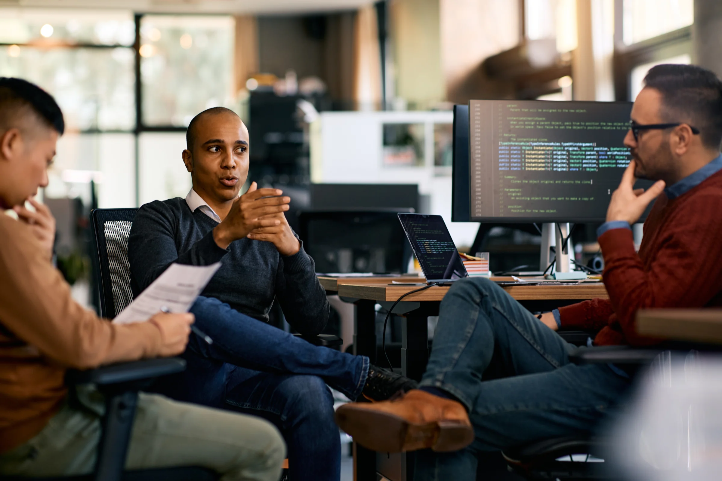 Technology team discussing a project in an office.